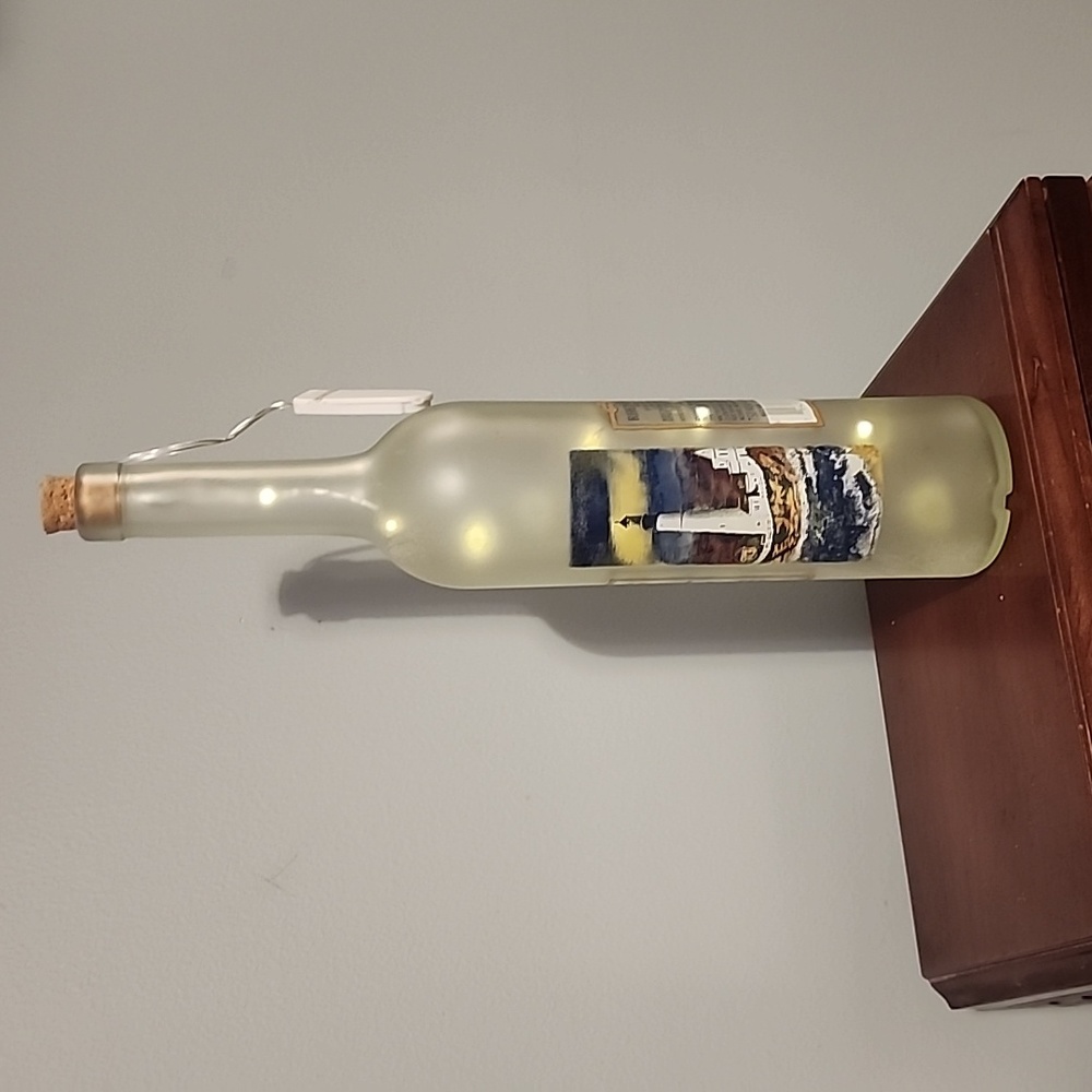Decorative lighted wine bottle,with lighthouses it.